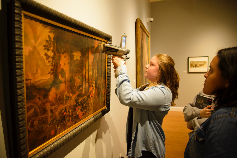 Chemistry major Sarah Farr'19 analyzes the painting Venus at the Forge of Vulcan with a handheld X-ray fluorescence spectrometer in the W...